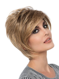 headshot of model wearing golden chin length wig