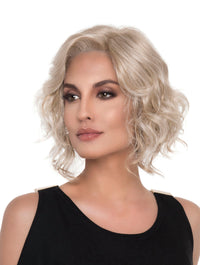 headshot of model wearing blonde chin length wig