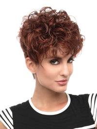 headshot of model wearing red curly pixie cut wig