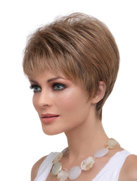headshot of model wearing strawberry blonde pixie style wig
