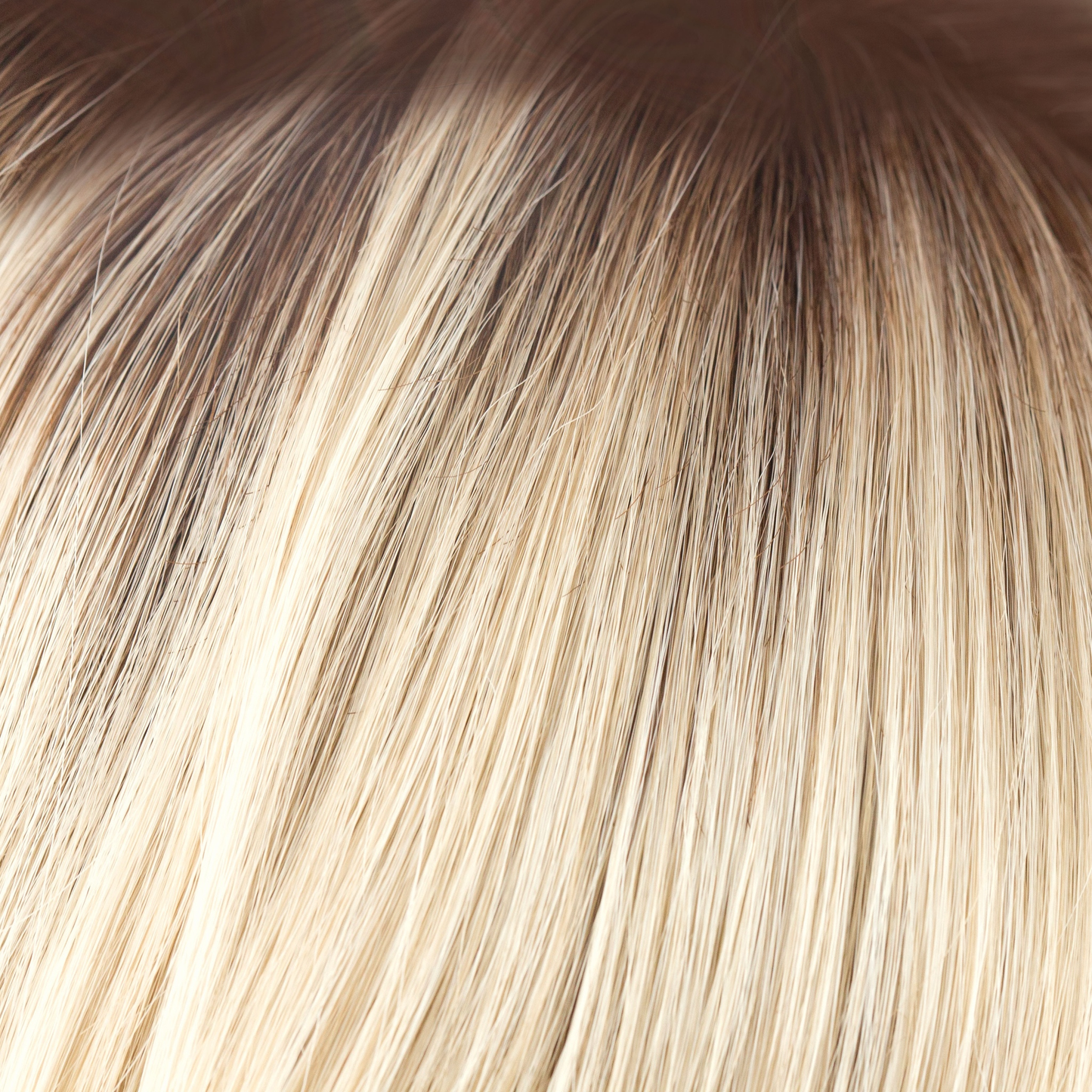 Champagne-R  -  A luxurious color with many fine tones of blond. Cream blonds, champagne hues and pale gold undertones make the blond a work of art! The medium warm brown root gives it the most natural of regrowths and keeps it looking very realistic.